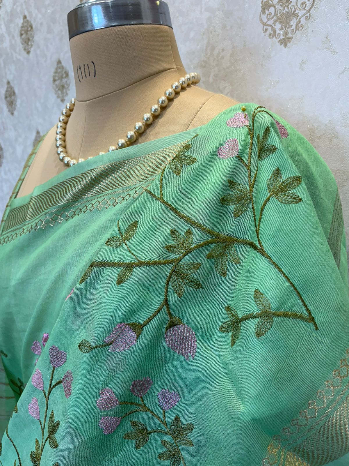 Mint Green Linen Saree with Floral Machine Embroidery & Zari Border